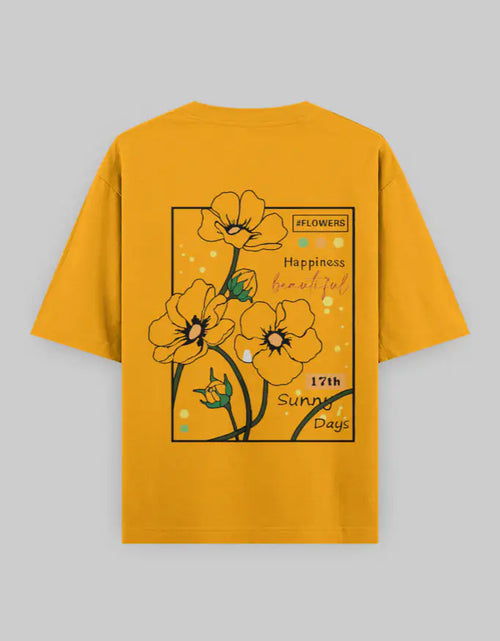 Oversized yellow t-shirt with bold flower graphic and text, streetwear style, back view