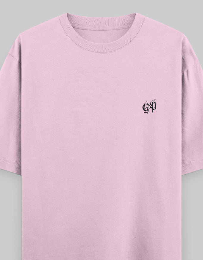 Light baby pink oversized unisex t-shirt with black graphic text on chest, heavyweight cotton.